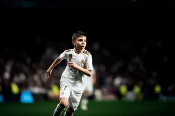 REAL MADRID App - Fast, responsive, and optimized for all devices A cheerful woman in traditional clothing using her smartphone during a festive moment, showing how easily the REAL MADRID app fits into everyday life.