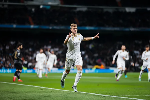 REAL MADRID - Step inside our high-end casino experience A glamorous woman holding casino chips in a neon-lit environment, representing the premium online casino atmosphere of REAL MADRID.