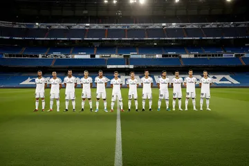 REAL MADRID Live Casino - Join thrilling real-dealer tables A professional dealer in a tuxedo greeting players at the roulette table, symbolizing the authentic live casino feel at REAL MADRID.