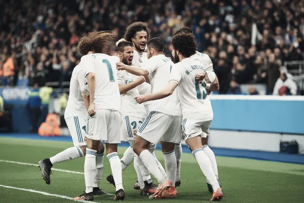 A player using their smartphone during a festive local event, representing REAL MADRID’s fully mobile-friendly casino.