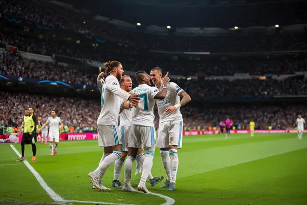 A confident dealer surrounded by casino chips inviting players to access their REAL MADRID account, reflecting quick and easy login options.