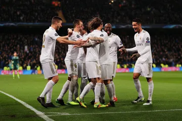 A laptop glowing with a bright login prompt in a minimalistic setup, symbolizing the protected access system at REAL MADRID.